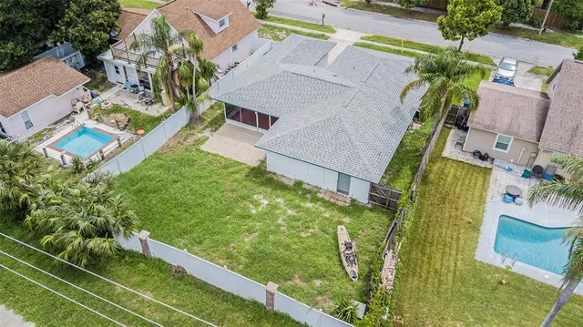 a aerial view of a house with a yard and plants