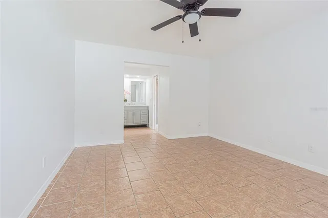 an empty room with a empty space and a ceiling fan