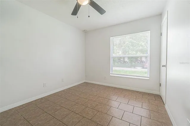 an empty room with a empty space and windows