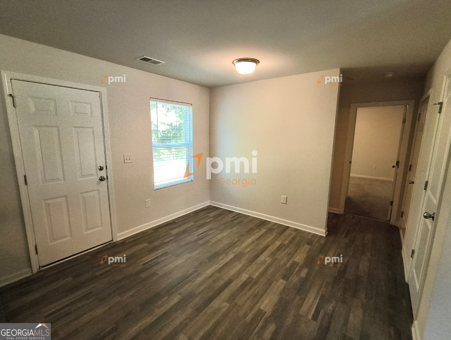 1552 Austin Drive Macon, GA 31217 - Photo 3 of 14 an empty room with wooden floor and windows