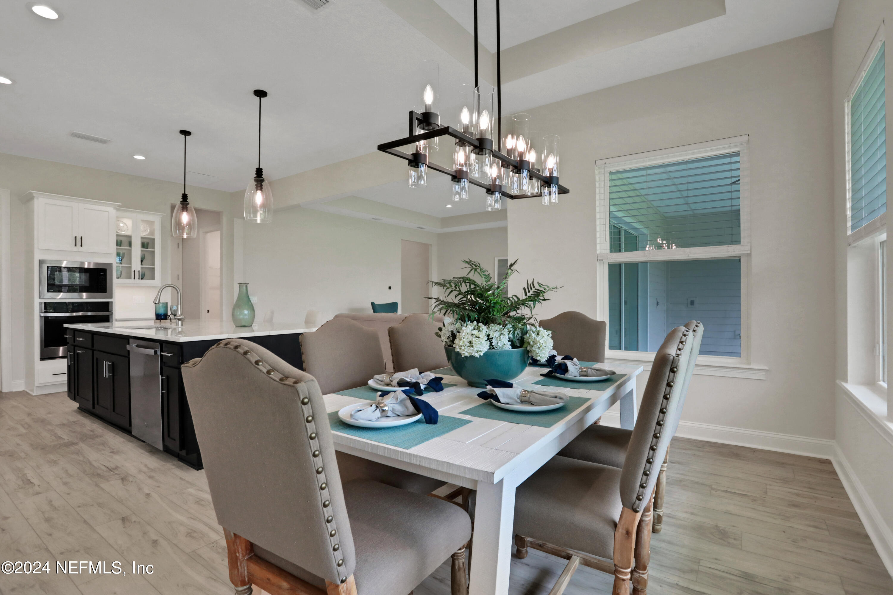 200 Tesoro Terrace St. Augustine, FL 32095 - Photo 15 of 32 a view of a dining room with furniture window and wooden floor
