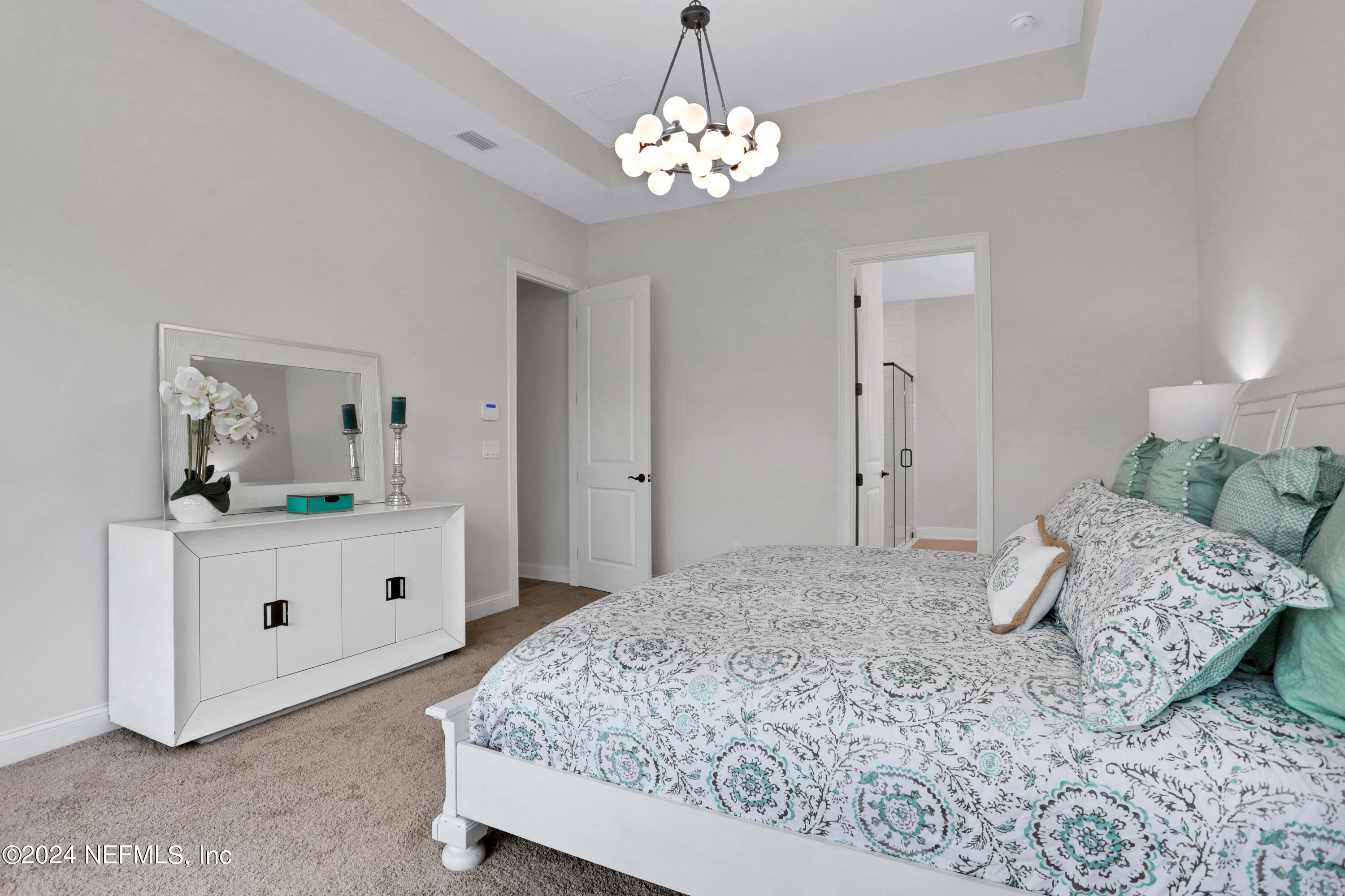 200 Tesoro Terrace St. Augustine, FL 32095 - Photo 17 of 32 a bedroom with a large bed and a chandelier