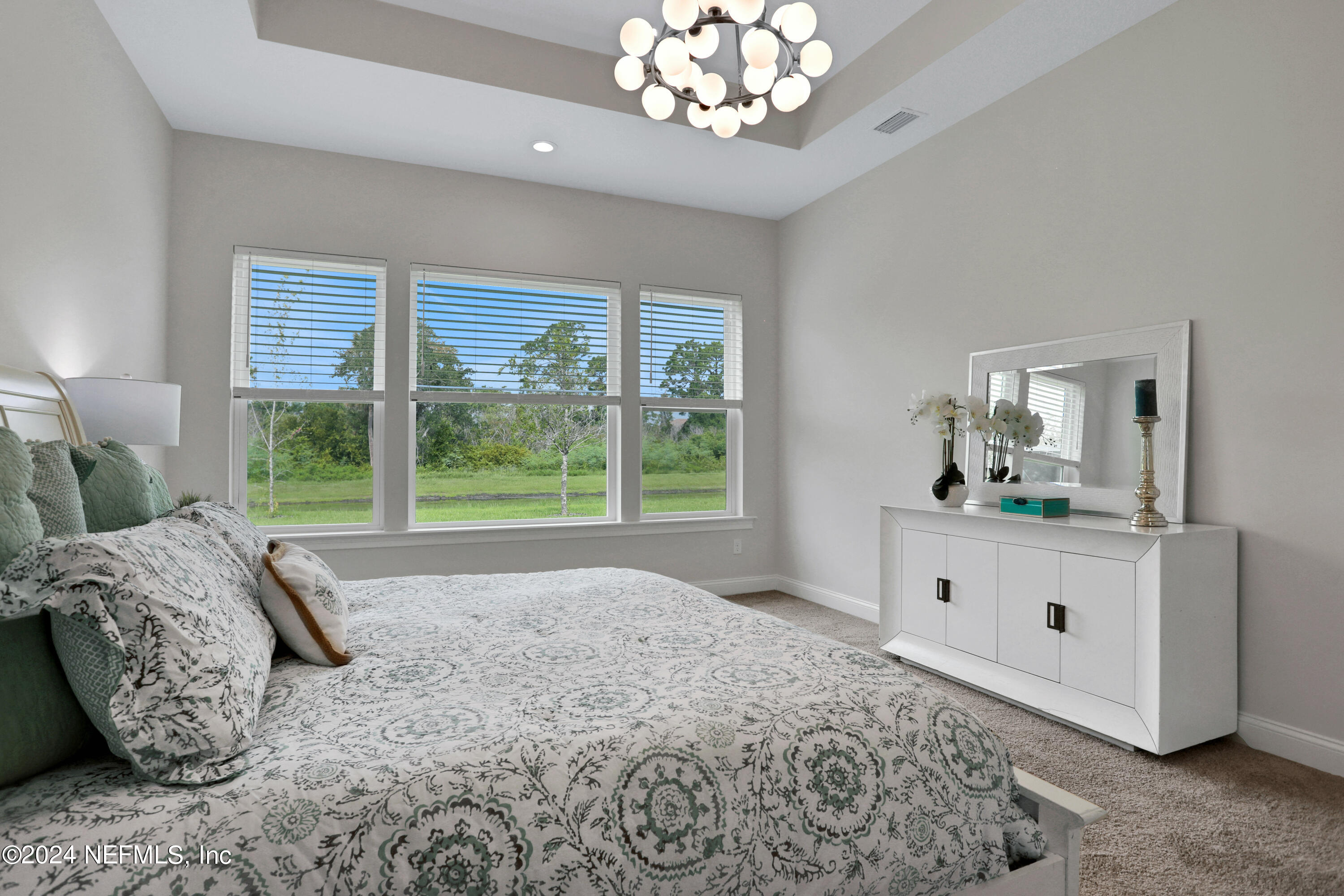 200 Tesoro Terrace St. Augustine, FL 32095 - Photo 18 of 32 a living room with a bed furniture and a large window
