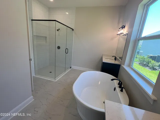 a bathroom with a tub shower and sink