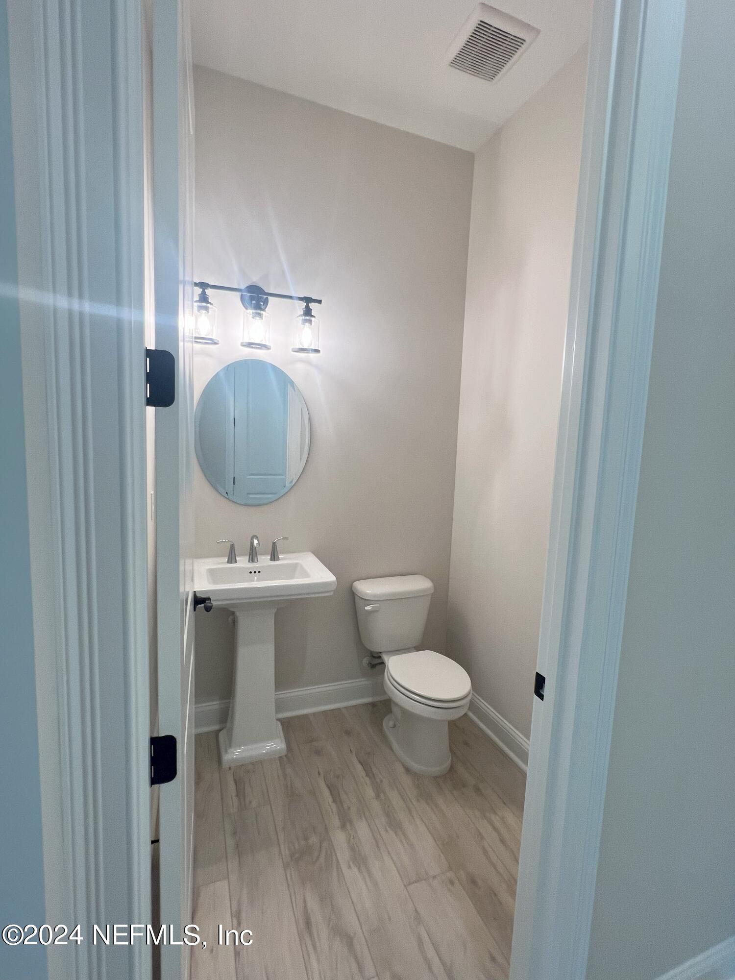200 Tesoro Terrace St. Augustine, FL 32095 - Photo 4 of 32 a view of a bathroom with a sink and a mirror