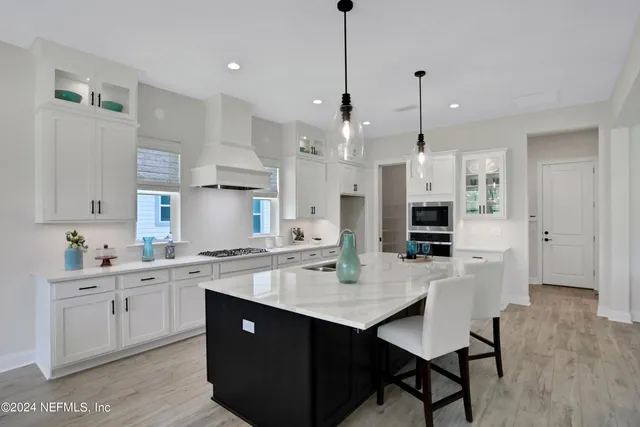 a kitchen with a sink center island and stainless steel appliances