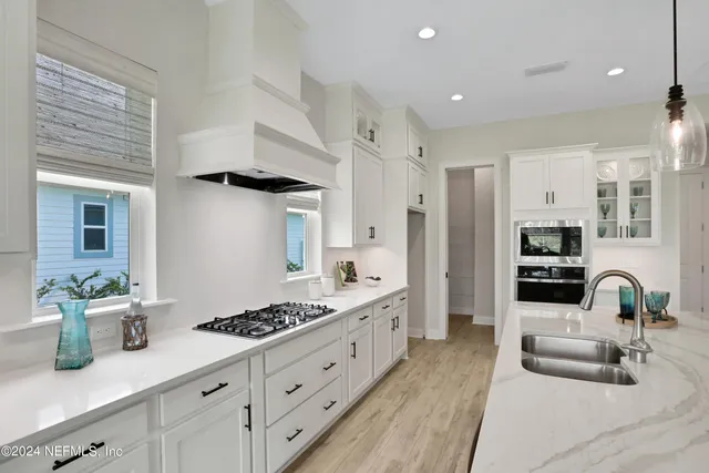 a kitchen with stainless steel appliances kitchen island granite countertop a sink and cabinets