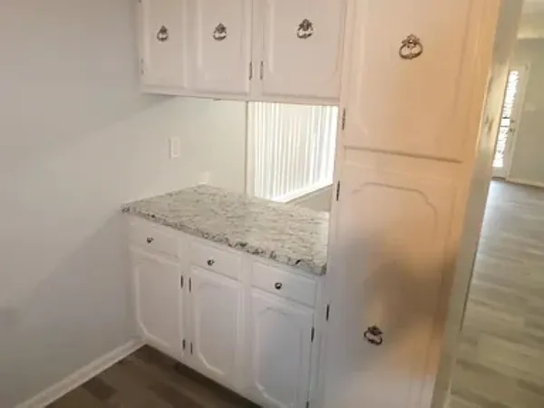 a bathroom with a granite countertop sink and vanity