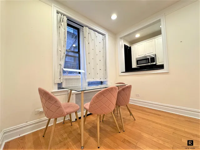 a dining room with furniture and window