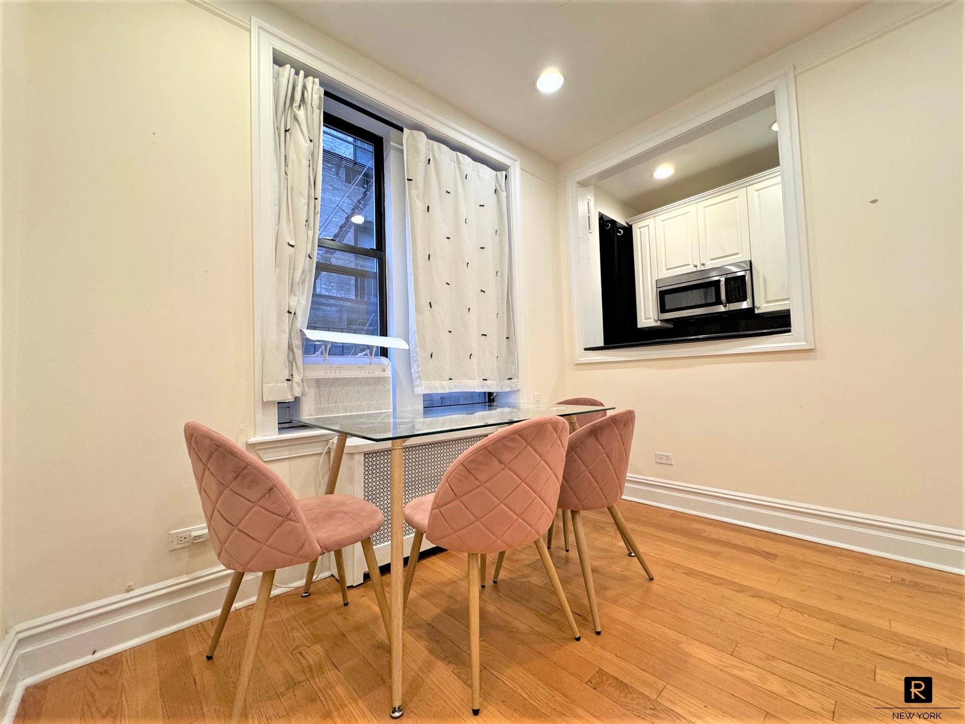 668 Riverside Drive, Unit 3H Manhattan, NY 10031 - Photo 2 of 5 a dining room with furniture and window
