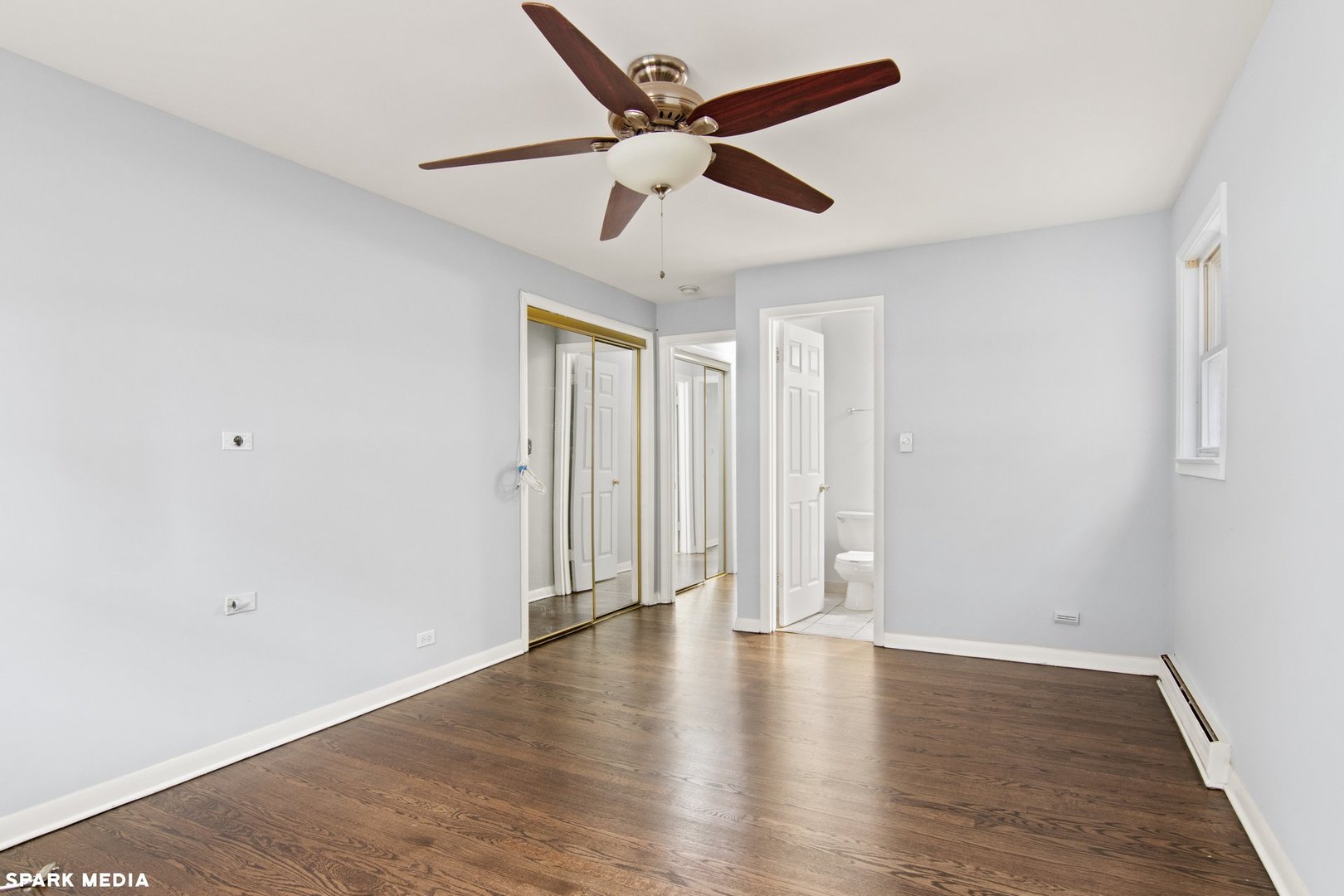 8847 La Crosse Avenue, Unit 204 Skokie, IL 60077 - Photo 15 of 16 an empty room with wooden floor ceiling fan and windows