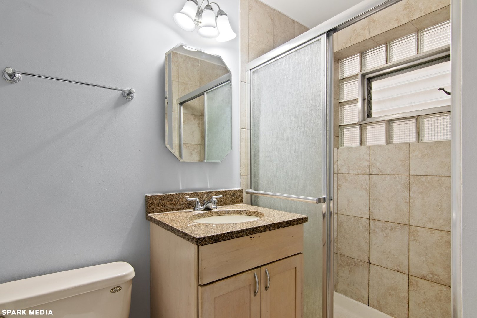8847 La Crosse Avenue, Unit 204 Skokie, IL 60077 - Photo 16 of 16 a bathroom with a sink a toilet and a mirror