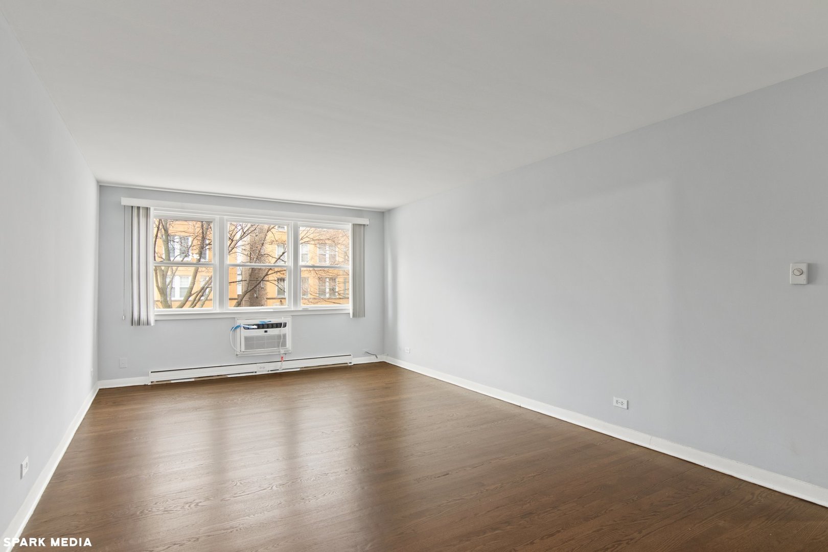 8847 La Crosse Avenue, Unit 204 Skokie, IL 60077 - Photo 5 of 16 an empty room with wooden floor and windows