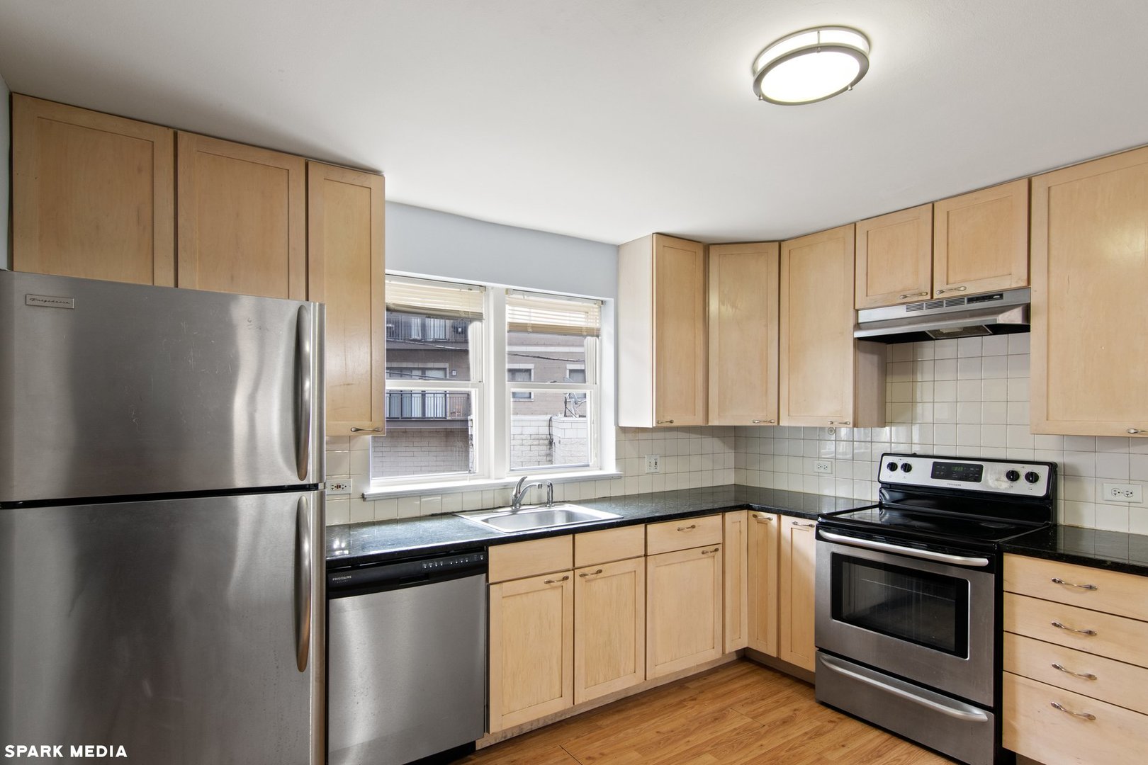 8847 La Crosse Avenue, Unit 204 Skokie, IL 60077 - Photo 9 of 16 a kitchen with granite countertop stainless steel appliances a refrigerator a sink and cabinets
