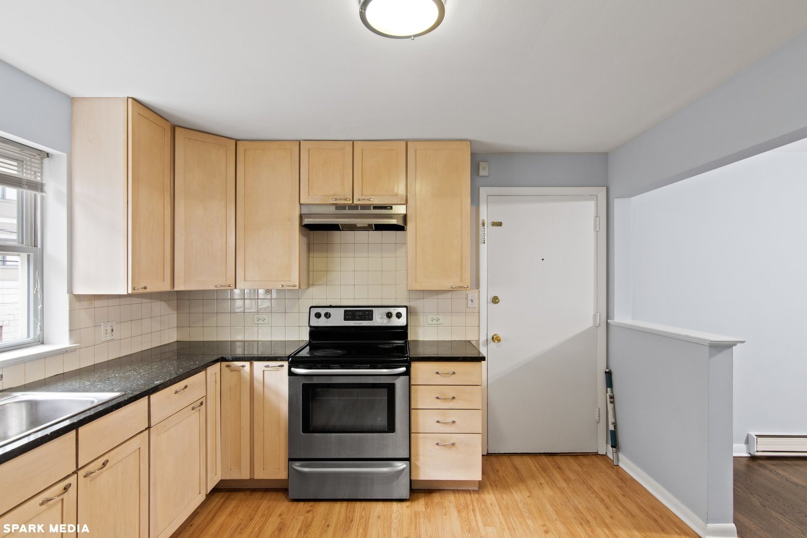 8847 La Crosse Avenue, Unit 204 Skokie, IL 60077 - Photo 10 of 16 a kitchen with a stove and a white wooden cabinets