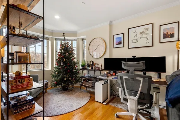 a living room with furniture a window and a flat screen tv