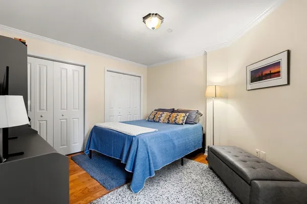 a bedroom with a bed and a couch