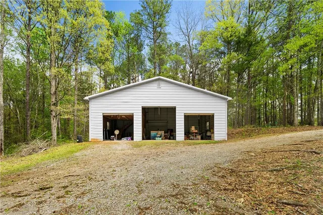 a view of a house with a yard and large tree