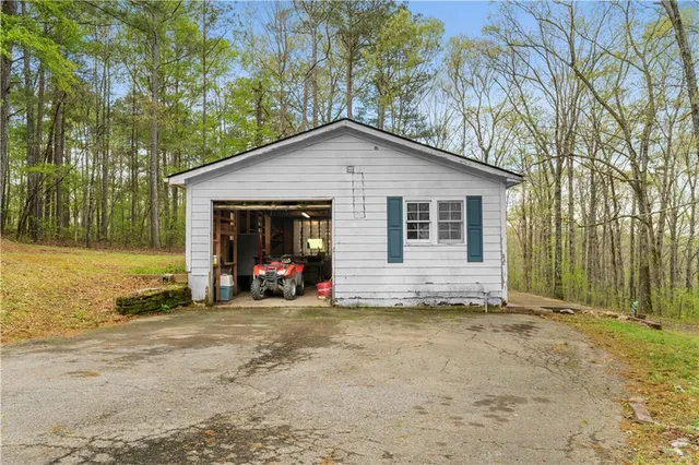 a kitchen with a sink a stove and a wooden floor