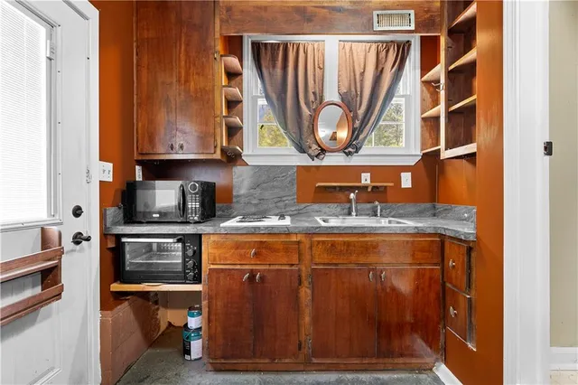 a kitchen with stainless steel appliances granite countertop a sink stove and cabinets