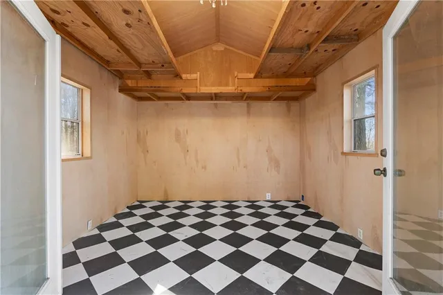 a view of a yard with wooden fence