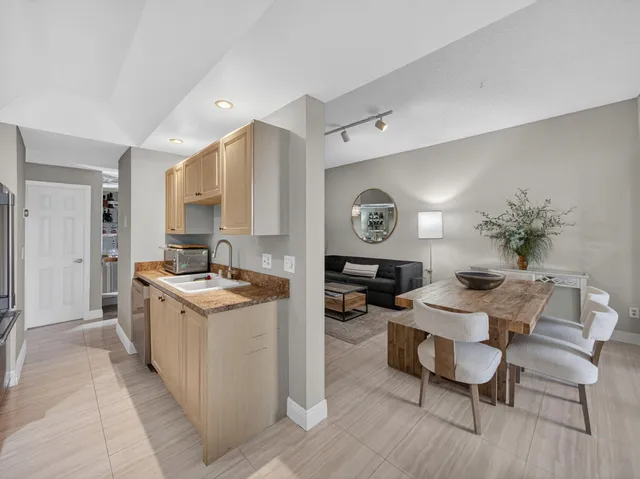 a kitchen that has a table and chairs in it