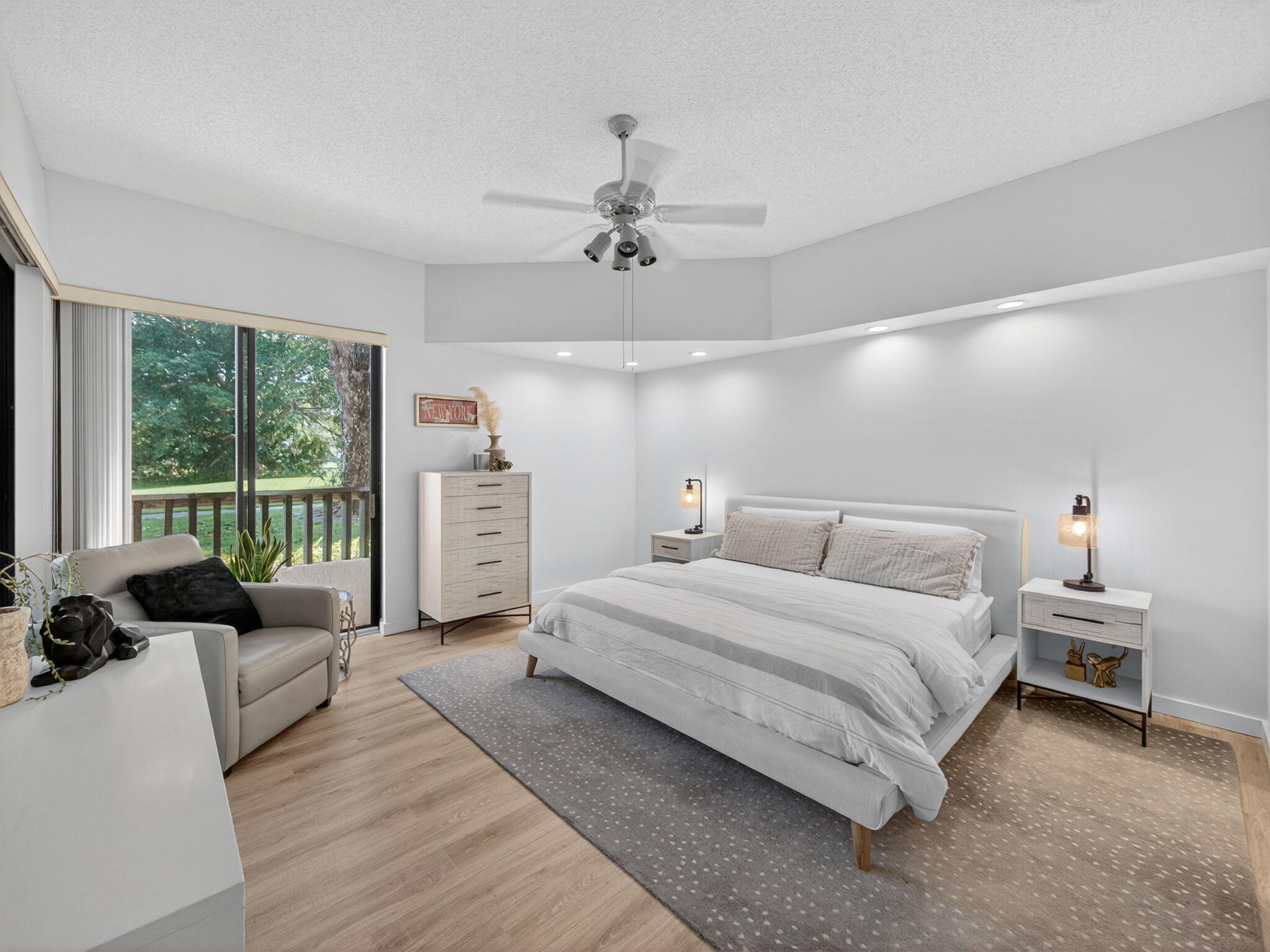 7472 La Paz Boulevard, Unit 109 Boca Raton, FL 33433 - Photo 14 of 29 a bedroom with a bed a couch and a window