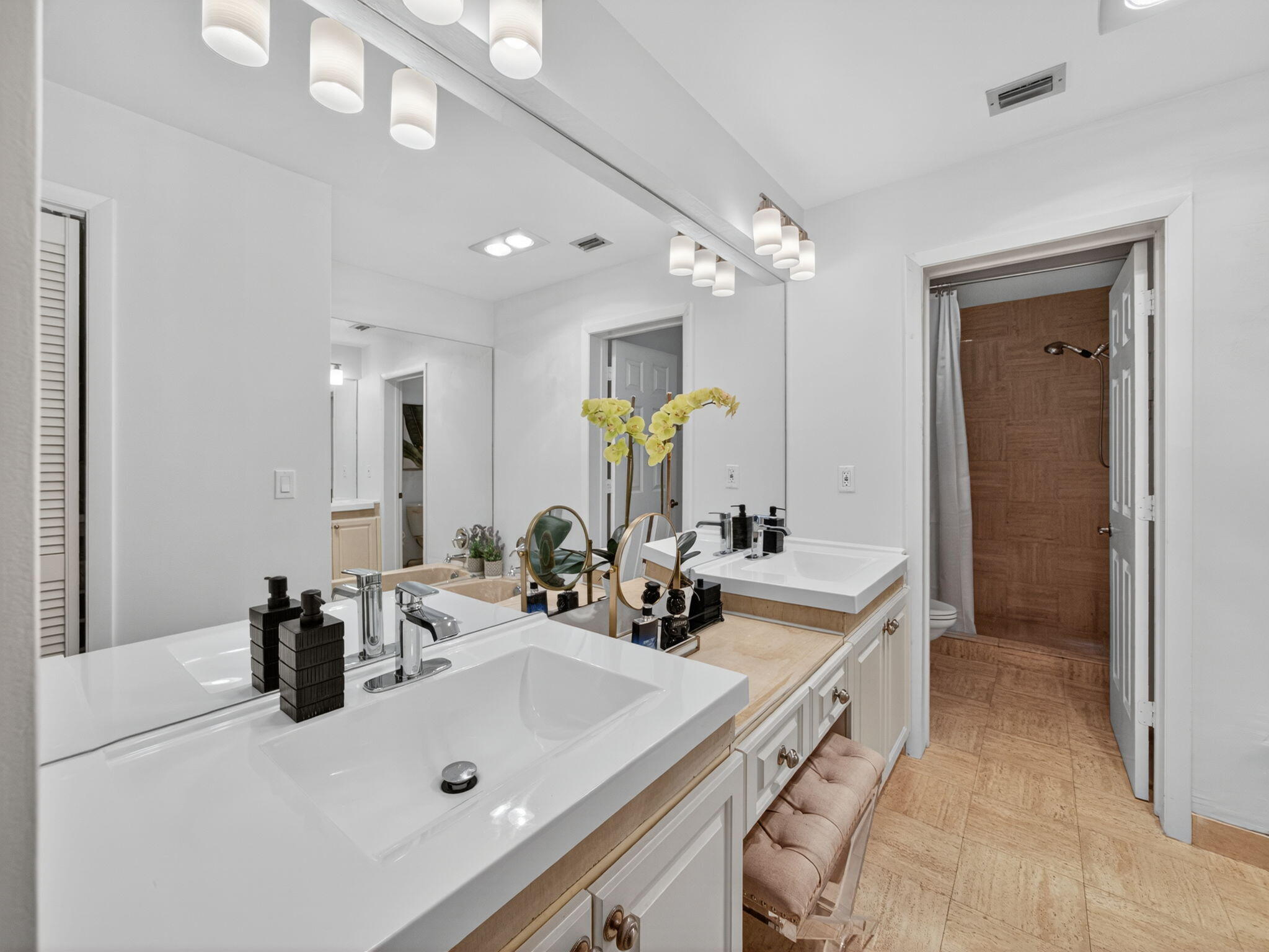 7472 La Paz Boulevard, Unit 109 Boca Raton, FL 33433 - Photo 16 of 29 a bathroom with a sink double vanity and a mirror