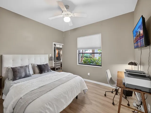 a bedroom with a bed a desk and chair