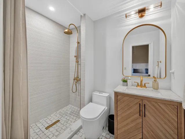 a bathroom with a sink toilet and shower