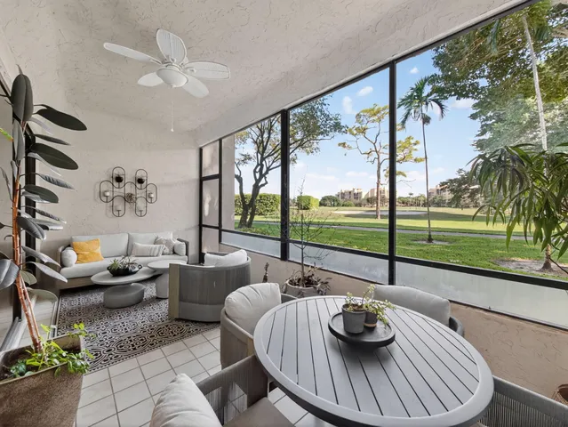 a view of a dining room with furniture wooden floor and a floor to ceiling window