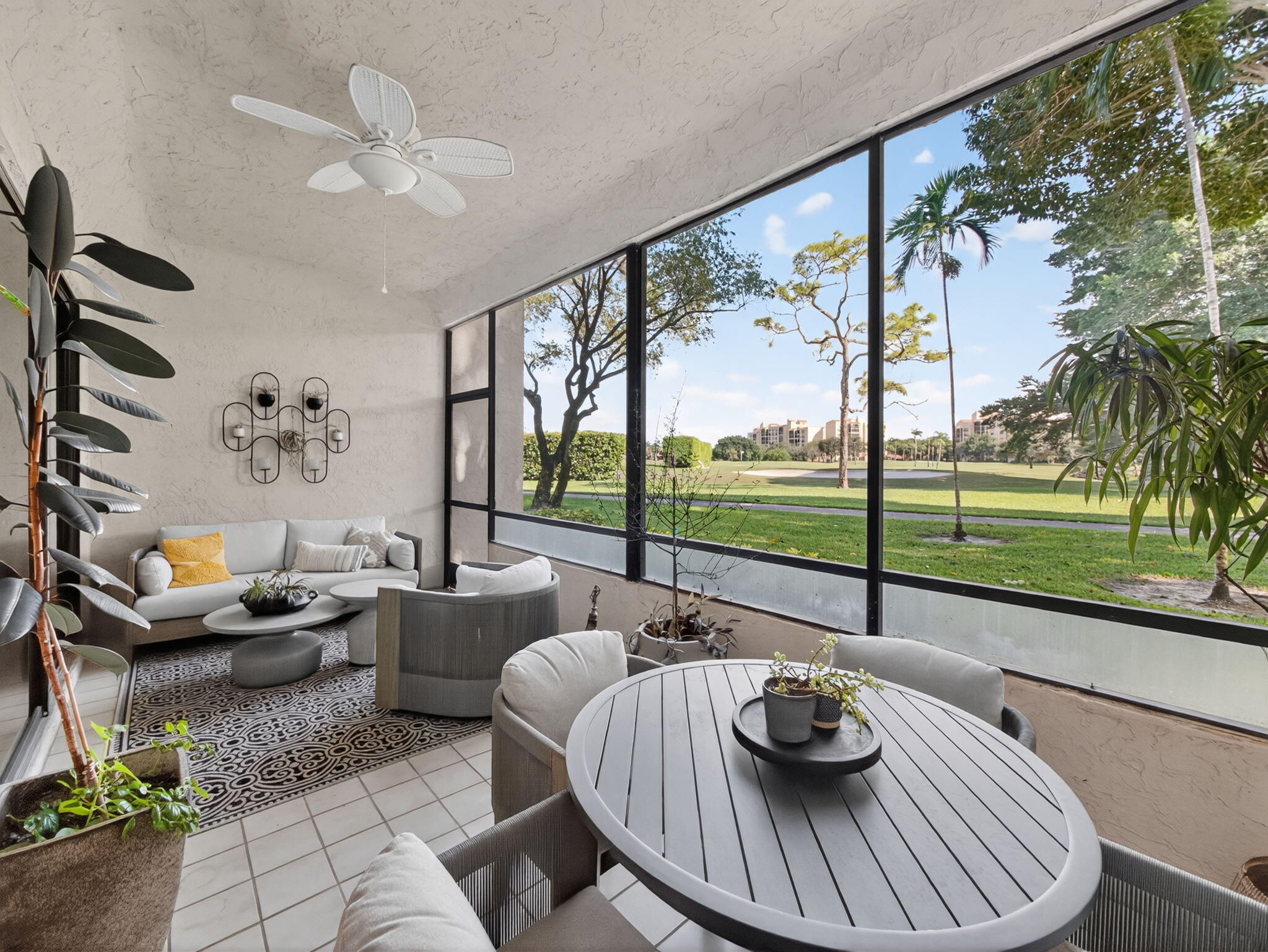 7472 La Paz Boulevard, Unit 109 Boca Raton, FL 33433 - Photo 23 of 29 a view of a dining room with furniture wooden floor and a floor to ceiling window