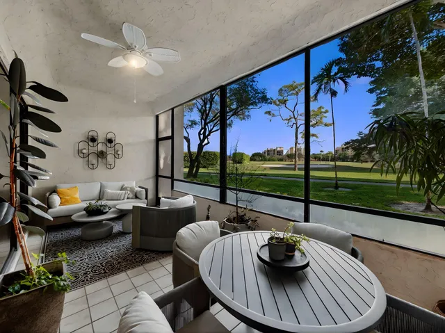 a living room with furniture and a floor to ceiling window