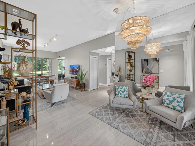 a living room with fireplace furniture and a chandelier