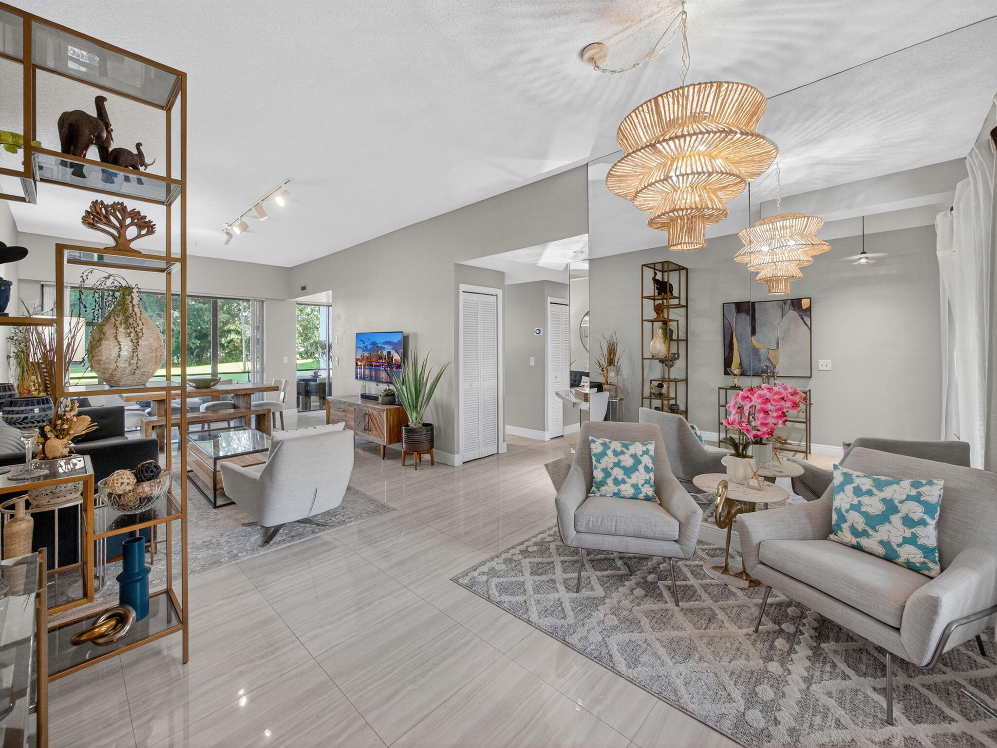 7472 La Paz Boulevard, Unit 109 Boca Raton, FL 33433 - Photo 3 of 29 a living room with fireplace furniture and a chandelier