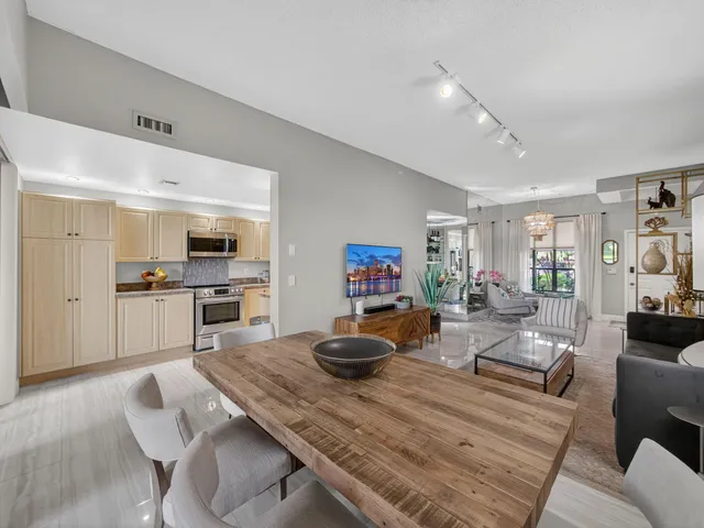a living room with furniture and kitchen view