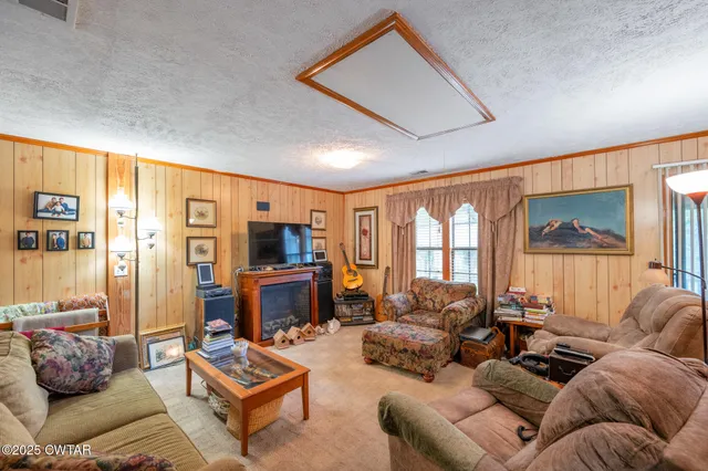 a bed room with two beds and next to a window