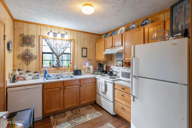 a balcony with wooden floor table and chairs
