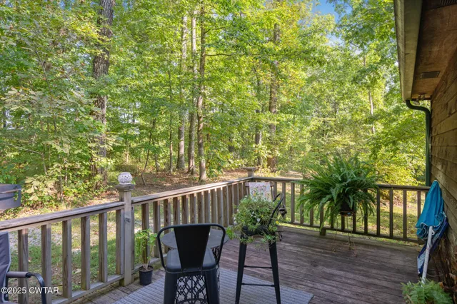 a living room with furniture and a large window with wooden floor