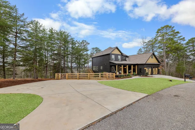 an aerial view of a house with garden and parking