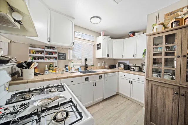 a kitchen with stainless steel appliances granite countertop a stove and a sink