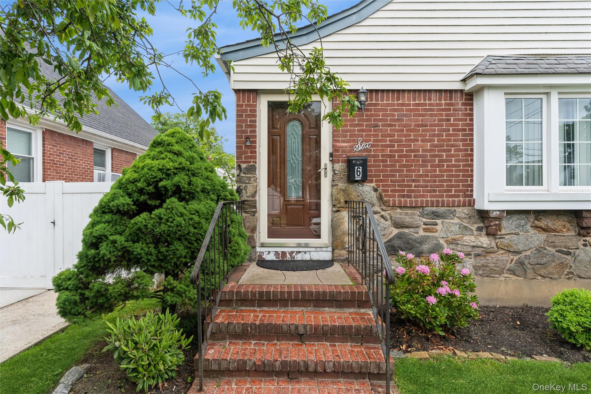 6 Jasper Street Valley Stream, NY 11580 - Photo 2 of 19 a front view of a house with a garden