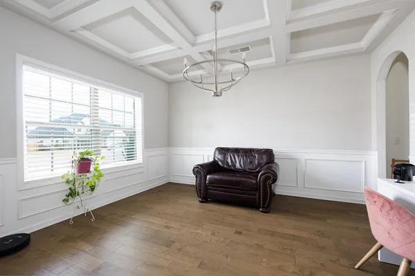 a spacious bedroom with furniture and a window