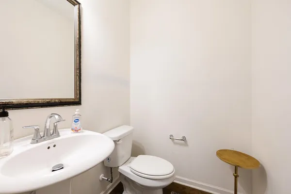 a bathroom with a sink a toilet and mirror