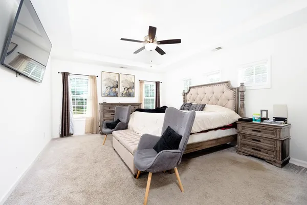 a bedroom with a bed and a chandelier