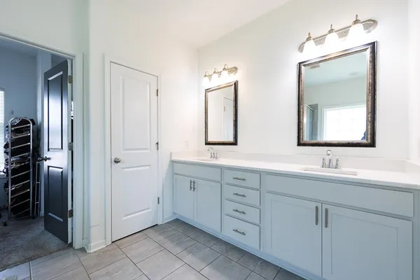 a bathroom with a double vanity sink and mirror
