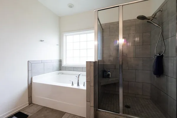 a bathroom with a bathtub and shower