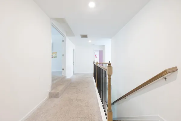 a view of a hallway with a refrigerator