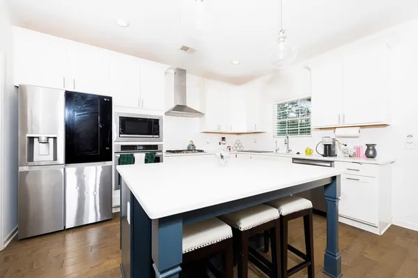 a large kitchen with a table and chairs