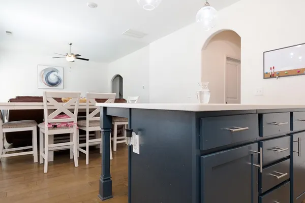 a view of a kitchen with stainless steel appliances cabinets and furniture